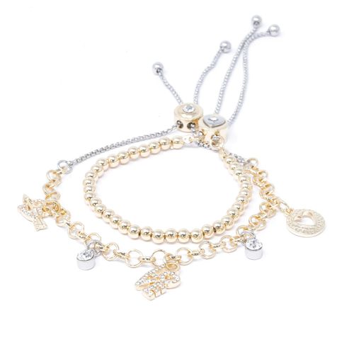 Brazalete Nes doble dorado con dijes de corazones y cruces de de brass para mujer