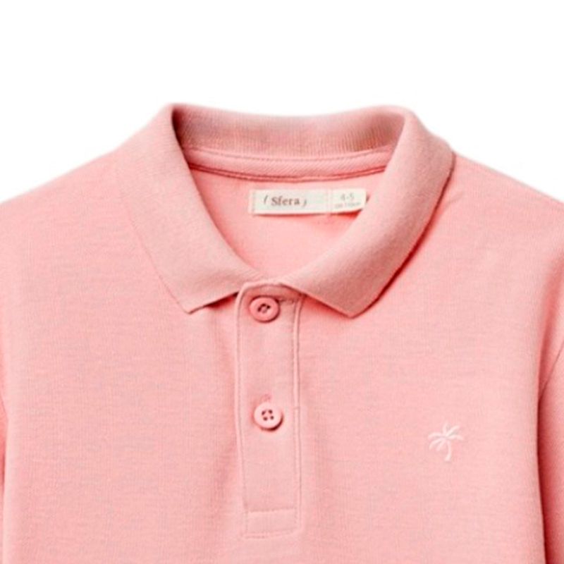 Camisa-polo-rosada-solido-para-niño-104874911