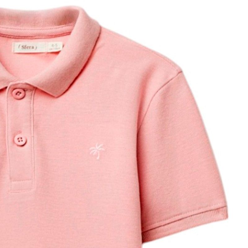 Camisa-polo-rosada-solido-para-niño-104874911