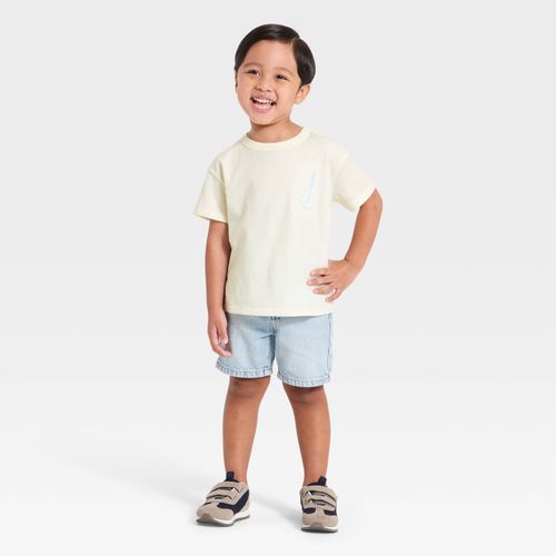 Camiseta beige con estampado tropical para niño