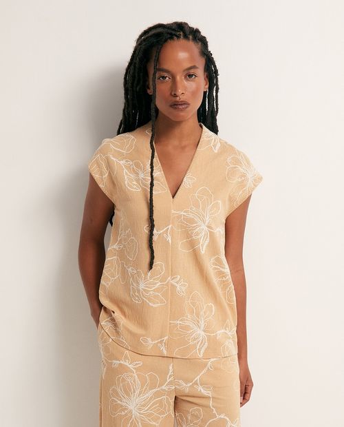 Blusa beige con estampado floral minimalista